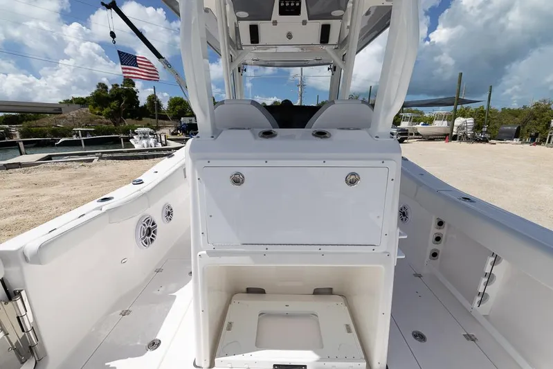  Yacht Photos Pics 2026 Sea Fox 288 Commander boat interior with seating and storage, docked under a cloudy sky.
