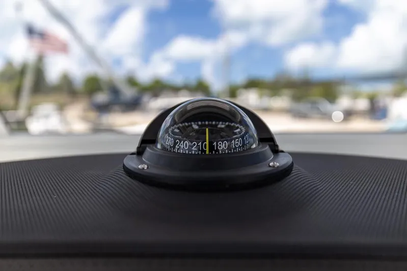  Yacht Photos Pics Compass on 2026 Sea Fox 288 Commander boat dashboard, with blurred outdoor background.
