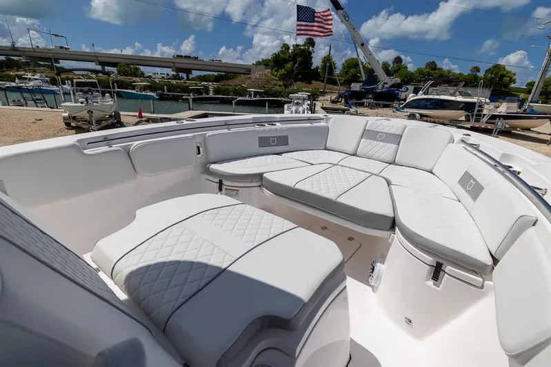  Yacht Photos Pics 2026 Sea Fox 288 Commander boat with luxurious white seating and American flag in background.