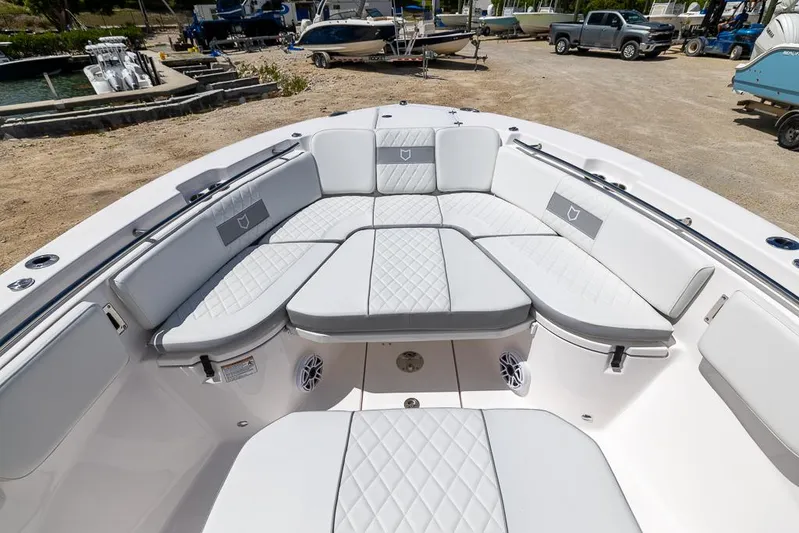  Yacht Photos Pics 2026 Sea Fox 288 Commander boat with spacious, cushioned seating in a marina setting.