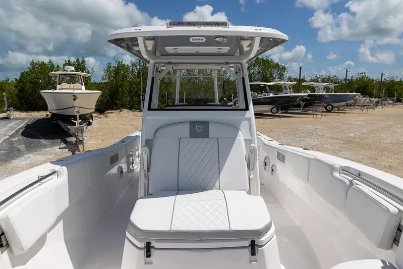  Yacht Photos Pics 2026 Sea Fox 288 Commander boat interior with white seating, parked on a sunny day.