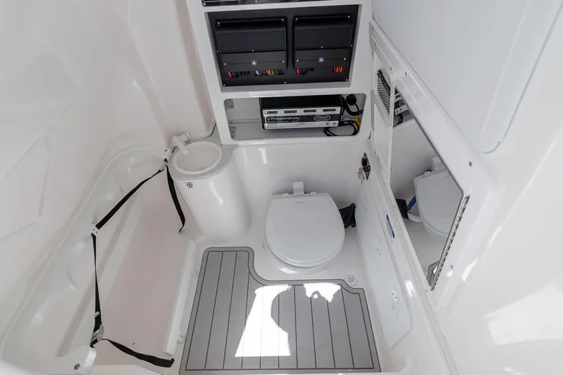  Yacht Photos Pics 2026 Sea Fox 288 Commander boat bathroom with toilet, storage, and control panels.