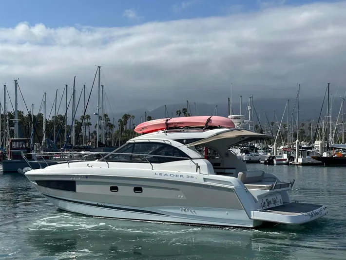 Le Bon Vie Yacht Photos Pics 2016 Jeanneau Leader 36 yacht in marina, overcast sky, pink kayak on top.