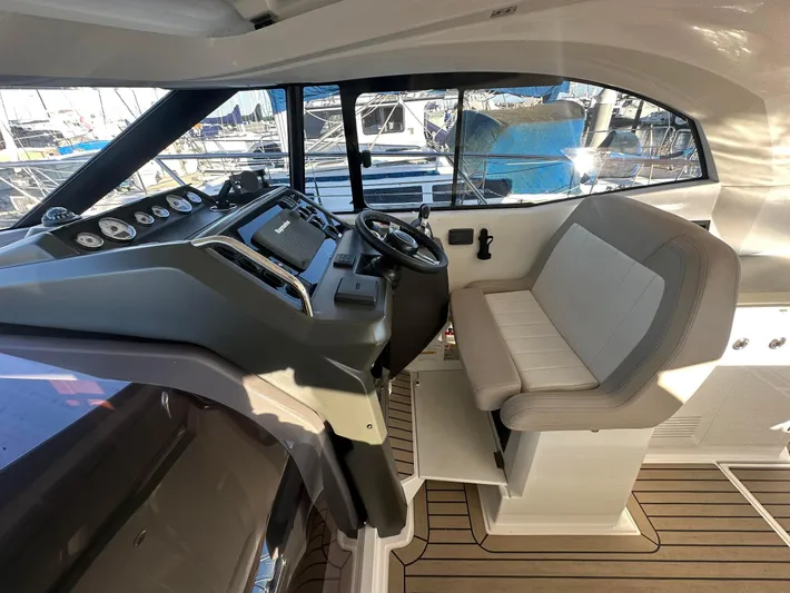 Le Bon Vie Yacht Photos Pics 2016 Jeanneau Leader 36 cockpit with steering wheel and seating, docked at marina.