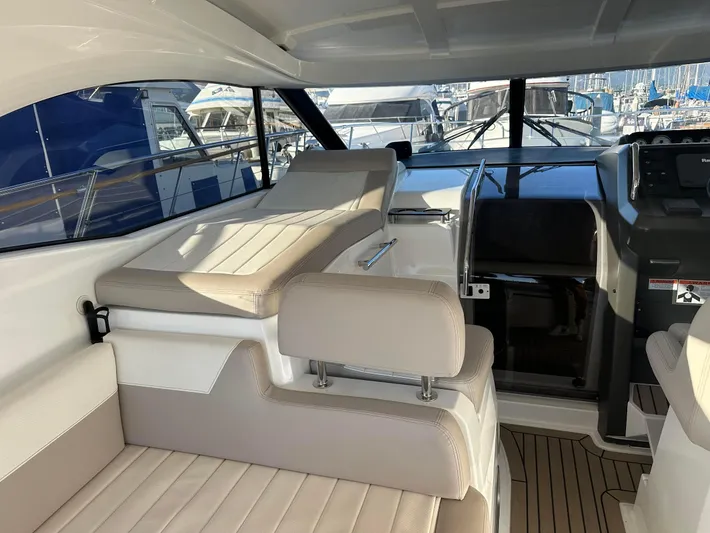 Le Bon Vie Yacht Photos Pics Interior of 2016 Jeanneau Leader 36 yacht with beige seating and helm station.