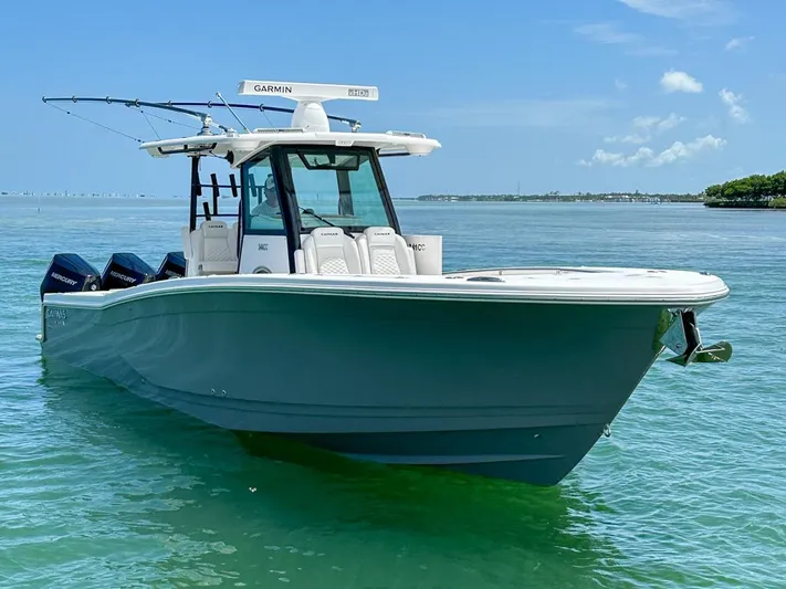  Yacht Photos Pics 2025 Caymas 341 CC boat on clear blue water under a sunny sky.