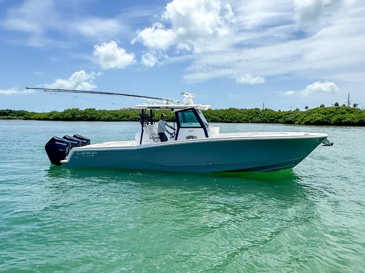  Yacht Photos Pics 2025 Caymas 341 CC boat on clear water under a blue sky.