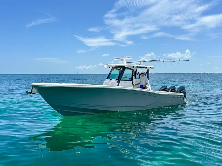  Yacht Photos Pics 2025 Caymas 341 CC boat on clear blue ocean under a sunny sky.