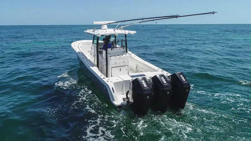  Yacht Photos Pics 2025 Caymas 341 CC boat with triple engines cruising on open ocean waters.