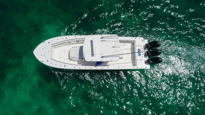  Yacht Photos Pics Aerial view of 2025 Caymas 341 CC boat on clear turquoise water.