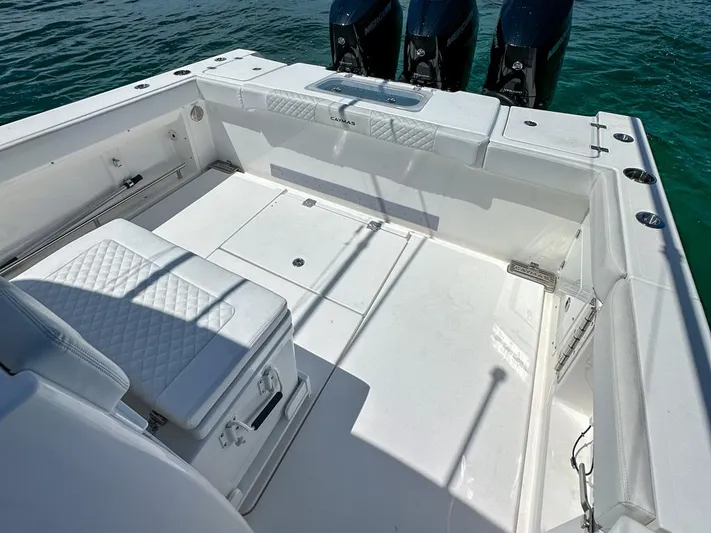  Yacht Photos Pics 2025 Caymas 341 CC boat deck with seating and triple outboard engines.