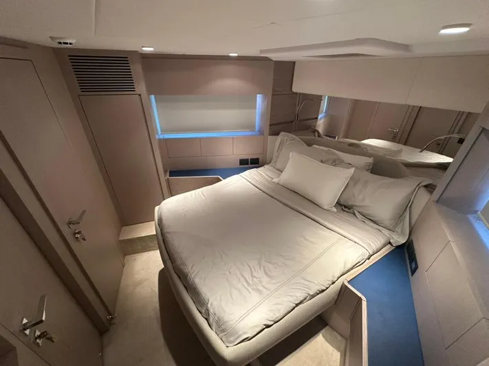  Yacht Photos Pics Luxurious bedroom interior of 2023 Ferretti Yachts 500 with modern design and cozy bedding.