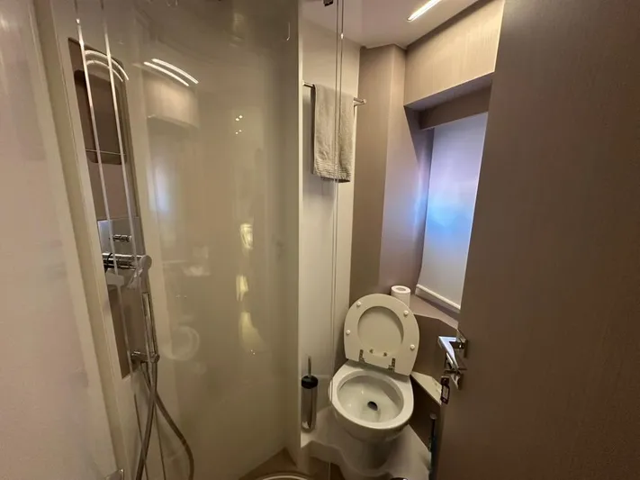  Yacht Photos Pics Modern bathroom in 2023 Ferretti Yachts 500, featuring shower and toilet.