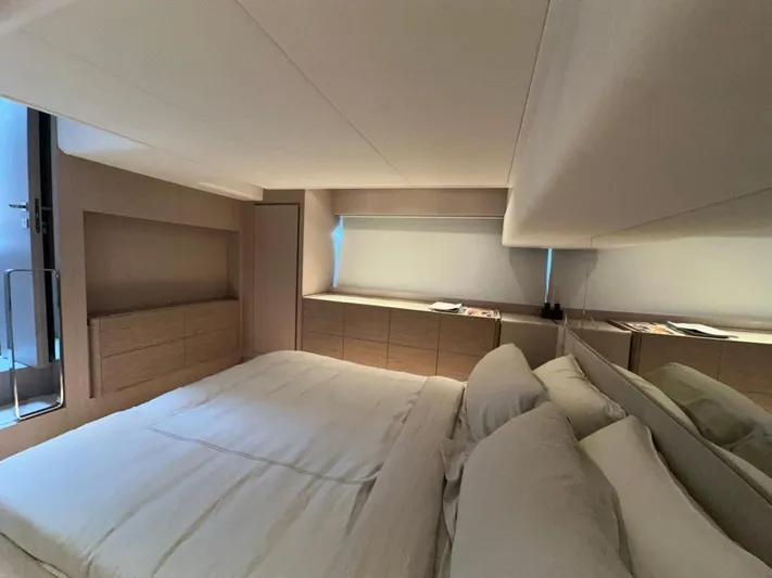  Yacht Photos Pics Luxurious bedroom interior of 2023 Ferretti Yachts 500, featuring modern design and elegant furnishings.