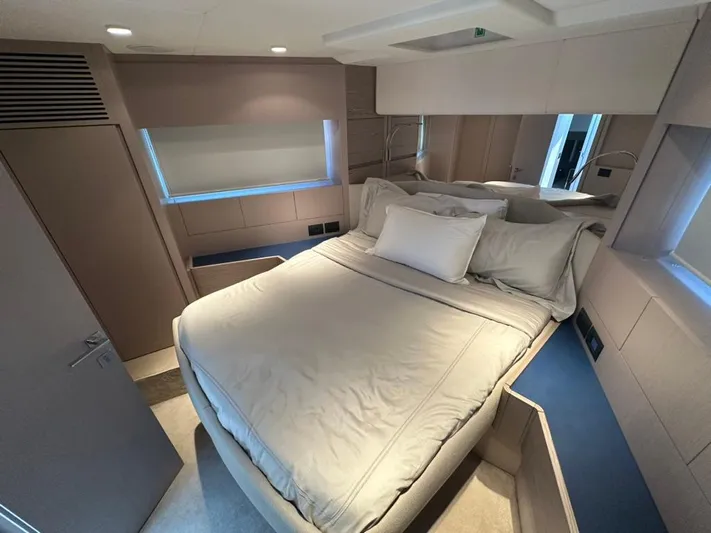  Yacht Photos Pics Luxurious bedroom interior of 2023 Ferretti Yachts 500 with modern design and cozy bedding.
