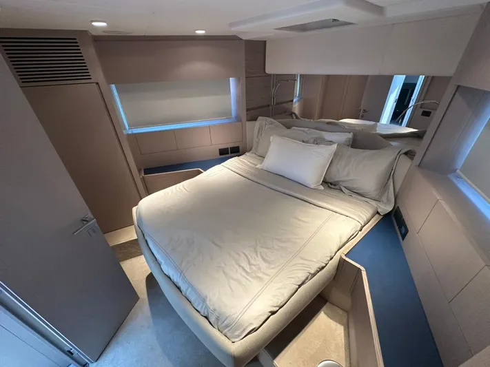  Yacht Photos Pics Luxurious bedroom interior of 2023 Ferretti Yachts 500 with modern design and cozy bedding.