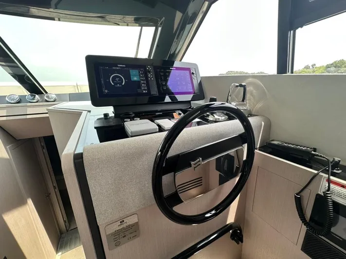  Yacht Photos Pics Helm of 2023 Ferretti Yachts 500 with modern navigation displays and steering wheel.