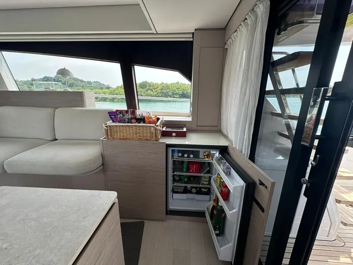  Yacht Photos Pics Luxurious interior of 2023 Ferretti Yachts 500 with open mini-fridge and scenic view.