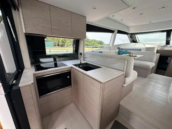  Yacht Photos Pics Luxurious interior of 2023 Ferretti Yachts 500, featuring modern kitchen and seating area.