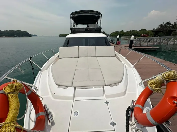  Yacht Photos Pics 2023 Ferretti Yachts 500 docked, featuring spacious sunbathing area and safety equipment.