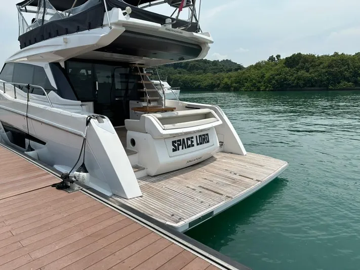 Yacht Photos Pics 2023 Ferretti Yachts 500 docked, rear view, with "Space Lord" name visible.
