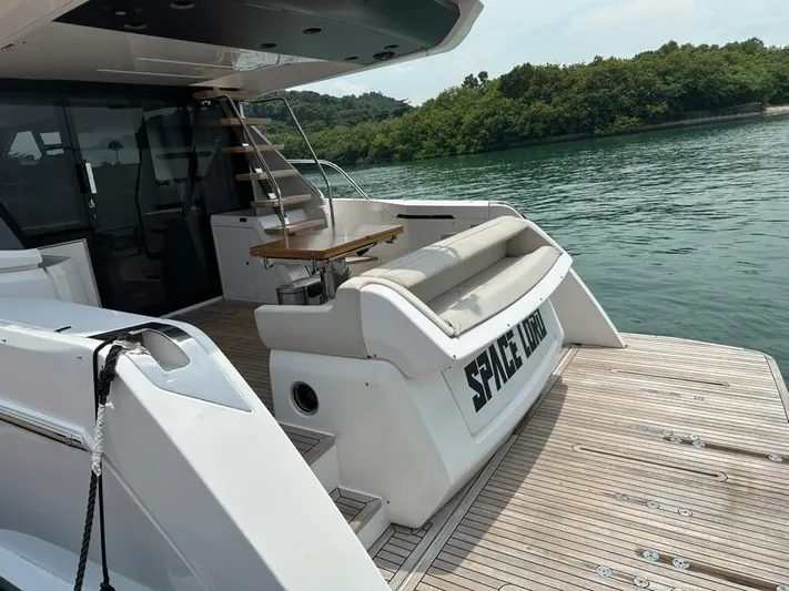  Yacht Photos Pics 2023 Ferretti Yachts 500, luxury yacht deck with seating, table, and scenic water view.