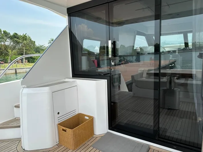  Yacht Photos Pics 2023 Ferretti Yachts 500 deck with glass doors and wicker basket.