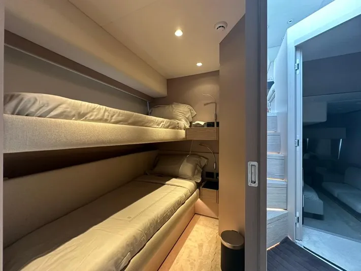  Yacht Photos Pics 2023 Ferretti Yachts 500 interior with cozy bunk beds and modern lighting.