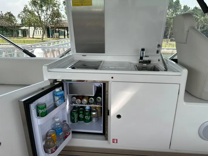  Yacht Photos Pics 2023 Ferretti Yachts 500 onboard kitchenette with open fridge and beverages.