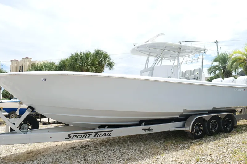  Yacht Photos Pics 2024 Contender 35 ST boat on Sport Trail trailer, parked outdoors.