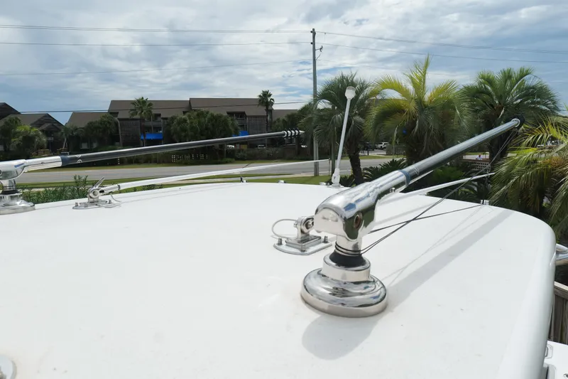  Yacht Photos Pics 2024 Contender 35 ST boat with antennas, surrounded by palm trees and buildings.