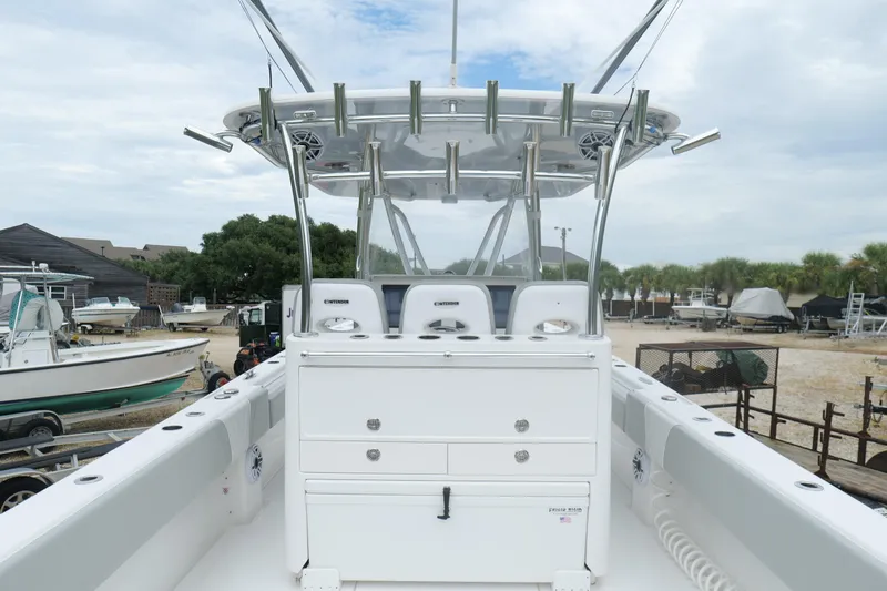  Yacht Photos Pics 2024 Contender 35 ST boat interior with fishing rod holders and seating, docked outdoors.