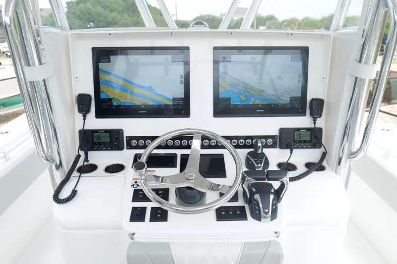  Yacht Photos Pics 2024 Contender 35 ST boat dashboard with dual Garmin displays and steering wheel.
