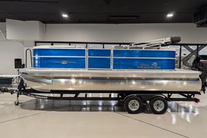 2026 Sun Tracker Party Barge 20 DLX pontoon boat on display indoors.