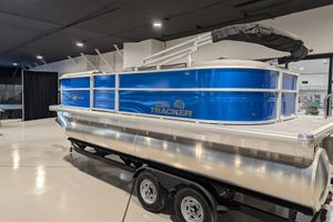 2026 Sun Tracker Party Barge 20 DLX pontoon boat in showroom, blue exterior.