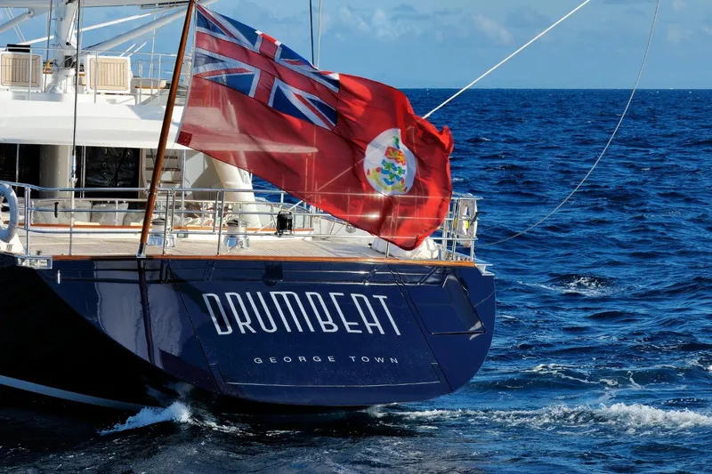 Drumbeat Yacht Photos Pics Sailing Ketch DRUMBEAT by Alloy Yachts, 2002, cruising on open sea with flag waving.
