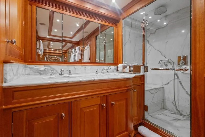 Drumbeat Yacht Photos Pics Luxurious yacht bathroom with marble shower and wooden cabinetry, Alloy Yachts Sailing Ketch DRUMBEAT 2002.