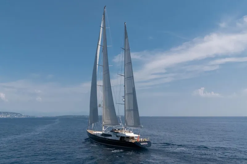 Drumbeat Yacht Photos Pics Sailing ketch DRUMBEAT by Alloy Yachts, 2002, cruising on open sea under clear skies.