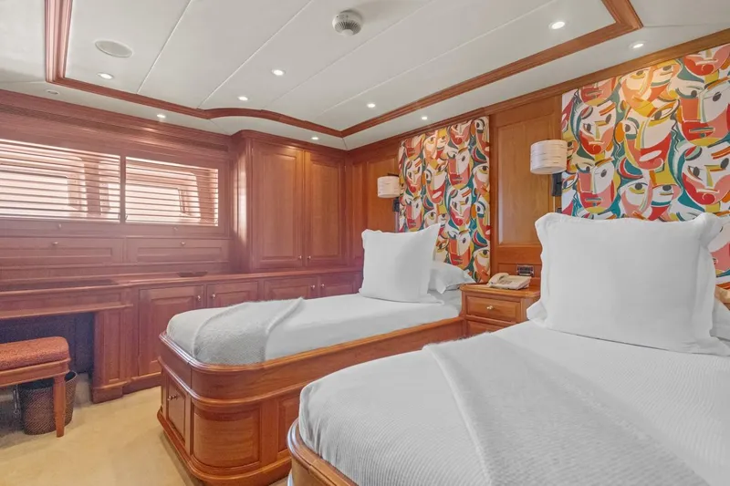 Drumbeat Yacht Photos Pics Luxurious twin cabin on Alloy Yachts' 2002 Sailing Ketch DRUMBEAT, featuring vibrant decor and wood paneling.