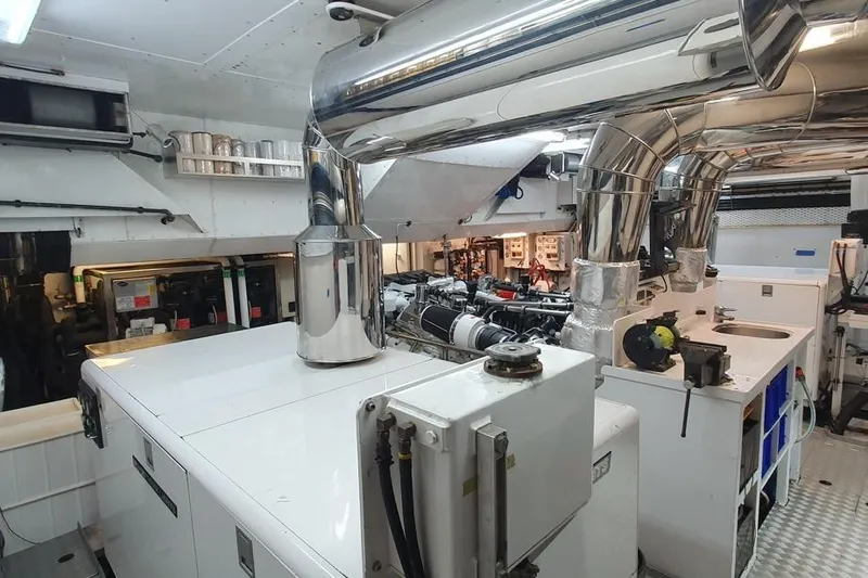 Drumbeat Yacht Photos Pics Engine room of 2002 Alloy Yachts Sailing Ketch DRUMBEAT, featuring polished metal pipes and machinery.