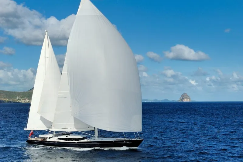 Drumbeat Yacht Photos Pics Sailing Ketch DRUMBEAT by Alloy Yachts, 2002, gliding on blue ocean under clear sky.