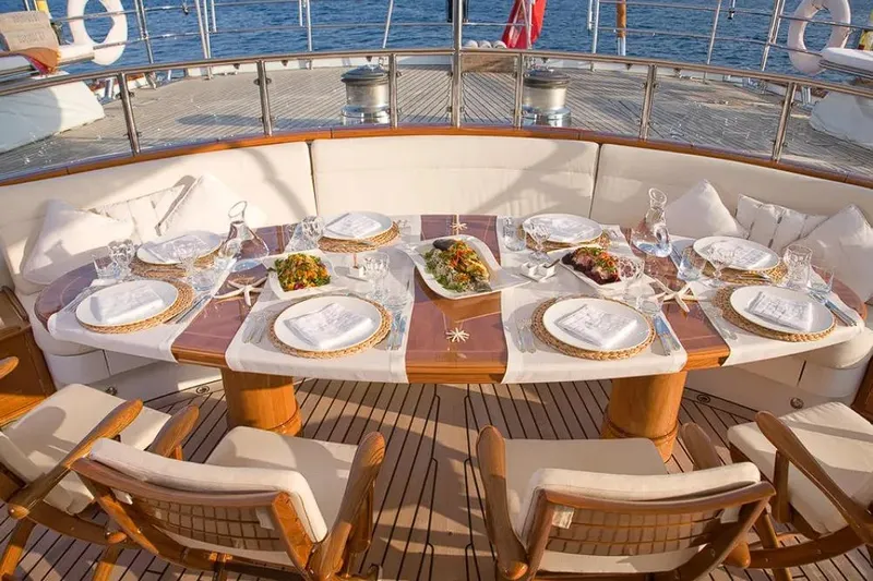 Drumbeat Yacht Photos Pics Luxurious dining setup on Alloy Yachts' 2002 Sailing Ketch DRUMBEAT, featuring elegant tableware.