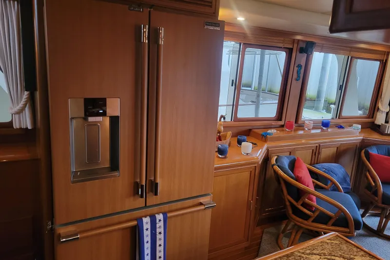 Miss Daisy Yacht Photos Pics Luxurious 2005 Fleming Pilothouse interior with wooden cabinetry and seating area.