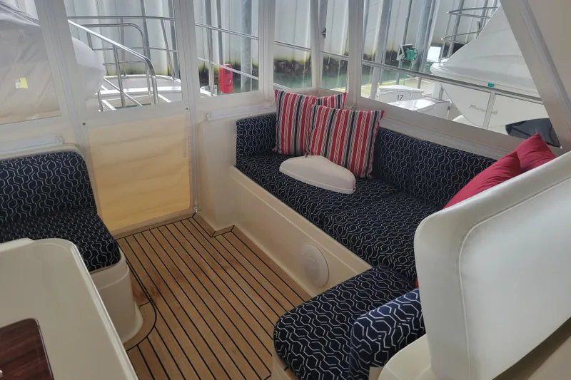 Miss Daisy Yacht Photos Pics 2005 Fleming Pilothouse interior with striped cushions and wooden flooring.