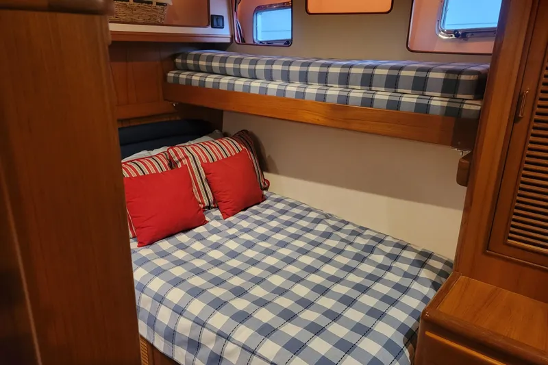 Miss Daisy Yacht Photos Pics 2005 Fleming Pilothouse cabin with bunk beds, plaid bedding, and red pillows.