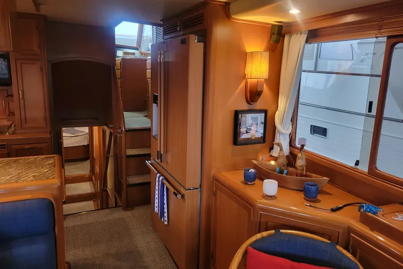 Miss Daisy Yacht Photos Pics Luxurious 2005 Fleming Pilothouse interior with wooden cabinetry and modern amenities.