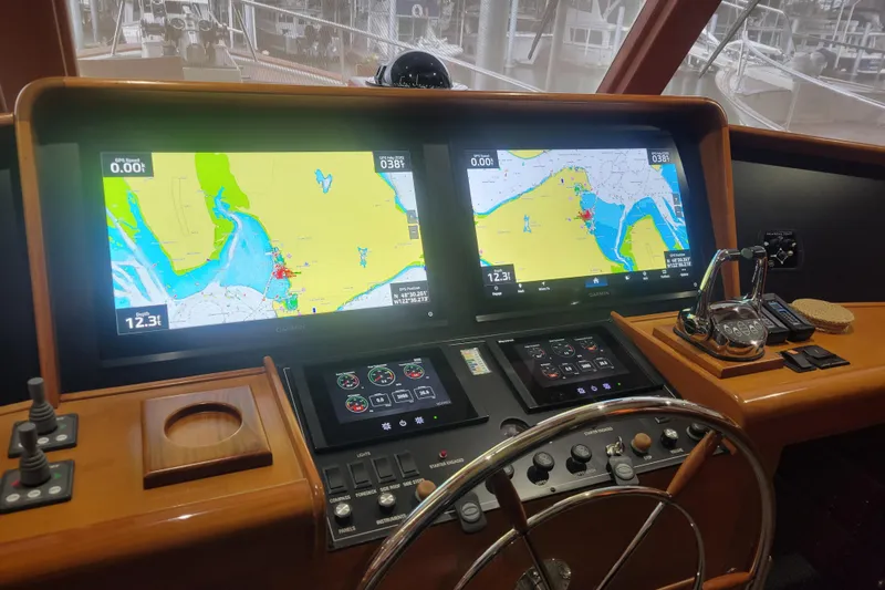 Miss Daisy Yacht Photos Pics Pilothouse of 2005 Fleming yacht with navigation screens and steering wheel.