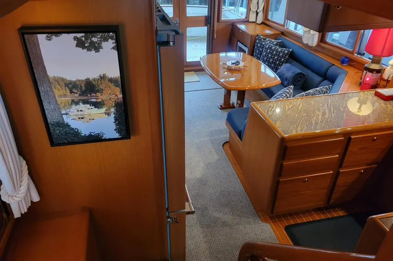 Miss Daisy Yacht Photos Pics Interior of 2005 Fleming Pilothouse yacht with cozy seating and elegant wood finishes.
