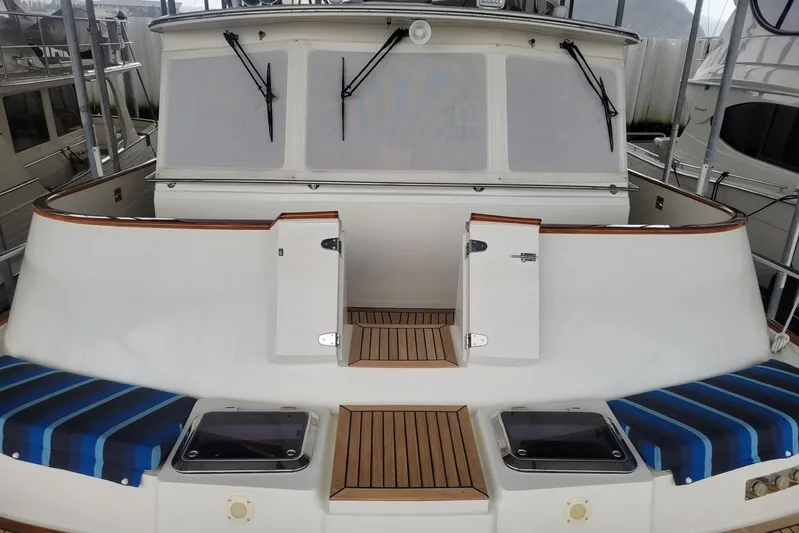 Miss Daisy Yacht Photos Pics 2005 Fleming Pilothouse yacht with striped cushions and wooden deck details.