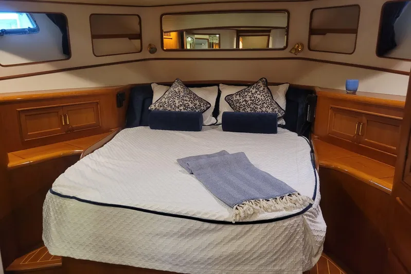 Miss Daisy Yacht Photos Pics Luxurious 2005 Fleming Pilothouse cabin with cozy bed and elegant wood finish.